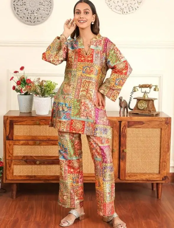 Aanchal in a patchwork print co-ord set beside a sideboard