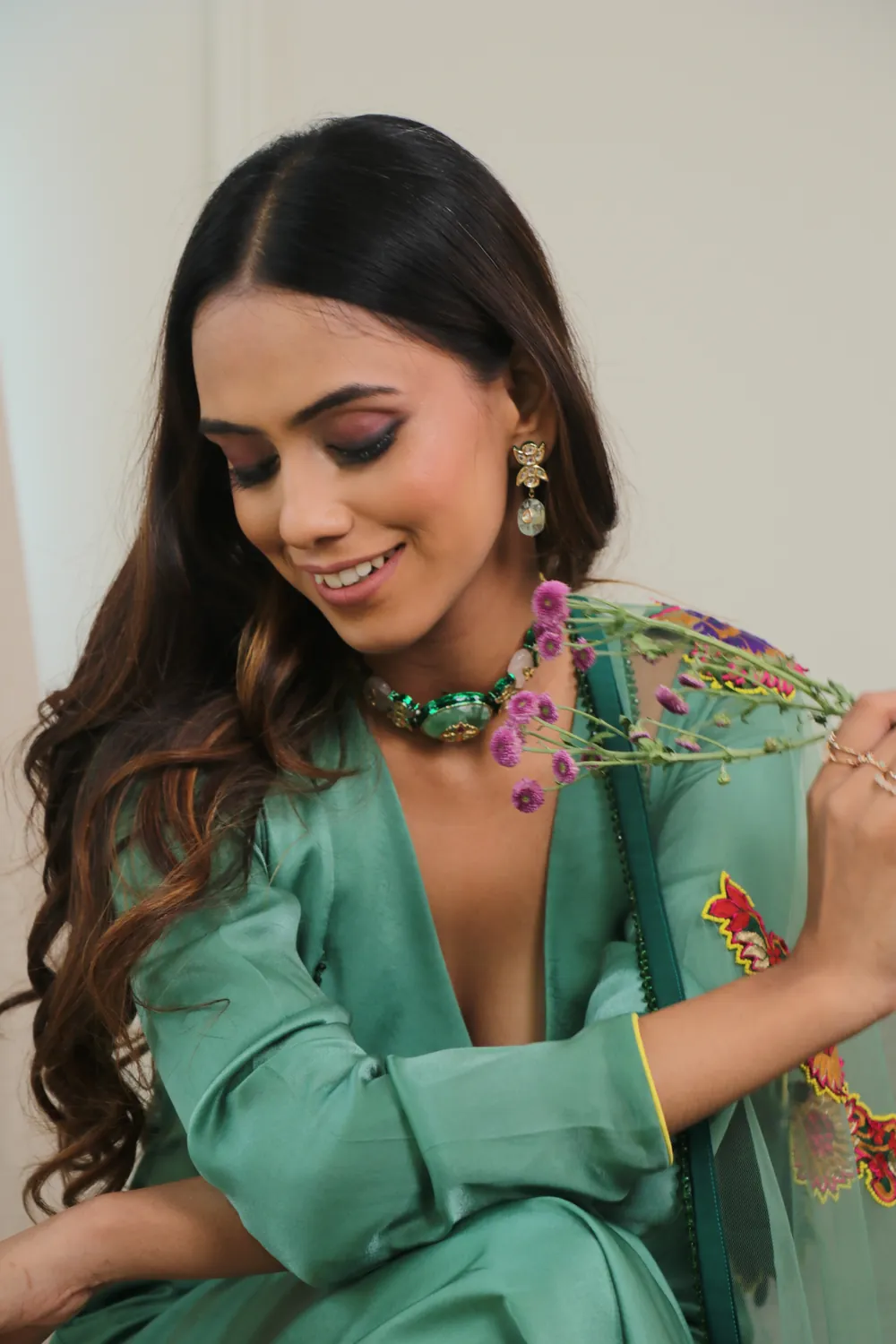 Aanchal in a green jacket and embroidered scarf