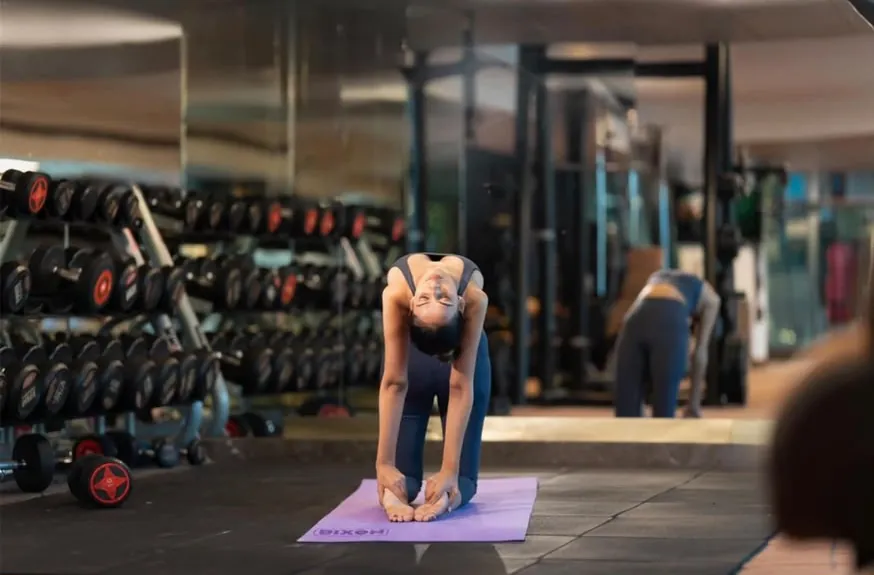 Aanchal stretching on a yoga mat in the Radisson Blu gym