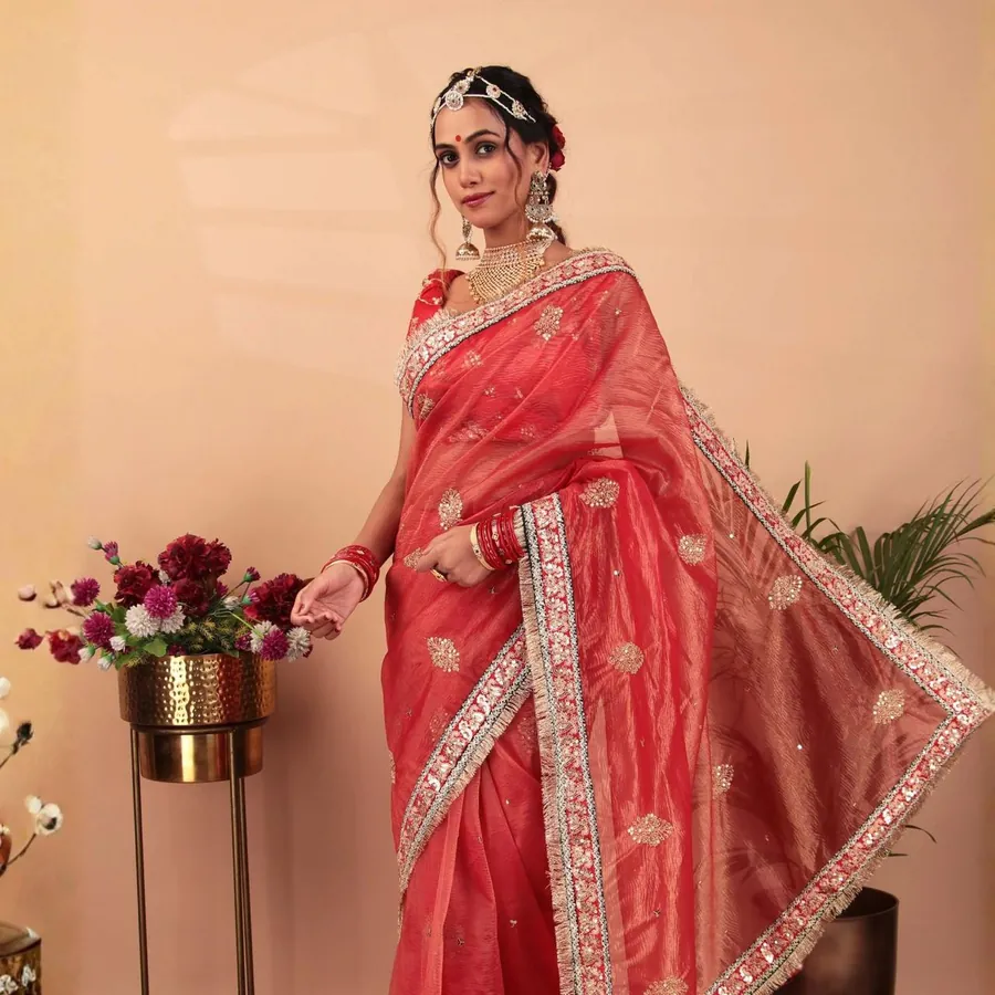 Aanchal in a coral saree with a gold border