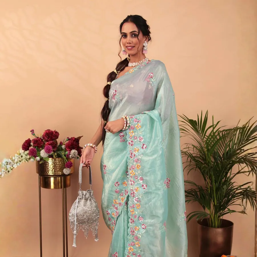 Aanchal in a mint saree holding a potli bag